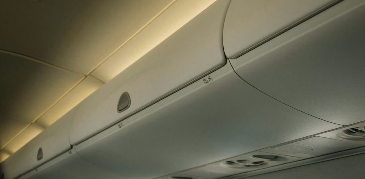 a line of luggage storage solutions in an airplane