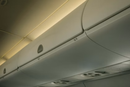 a line of luggage storage solutions in an airplane