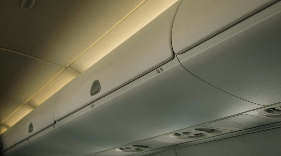 a line of luggage storage solutions in an airplane