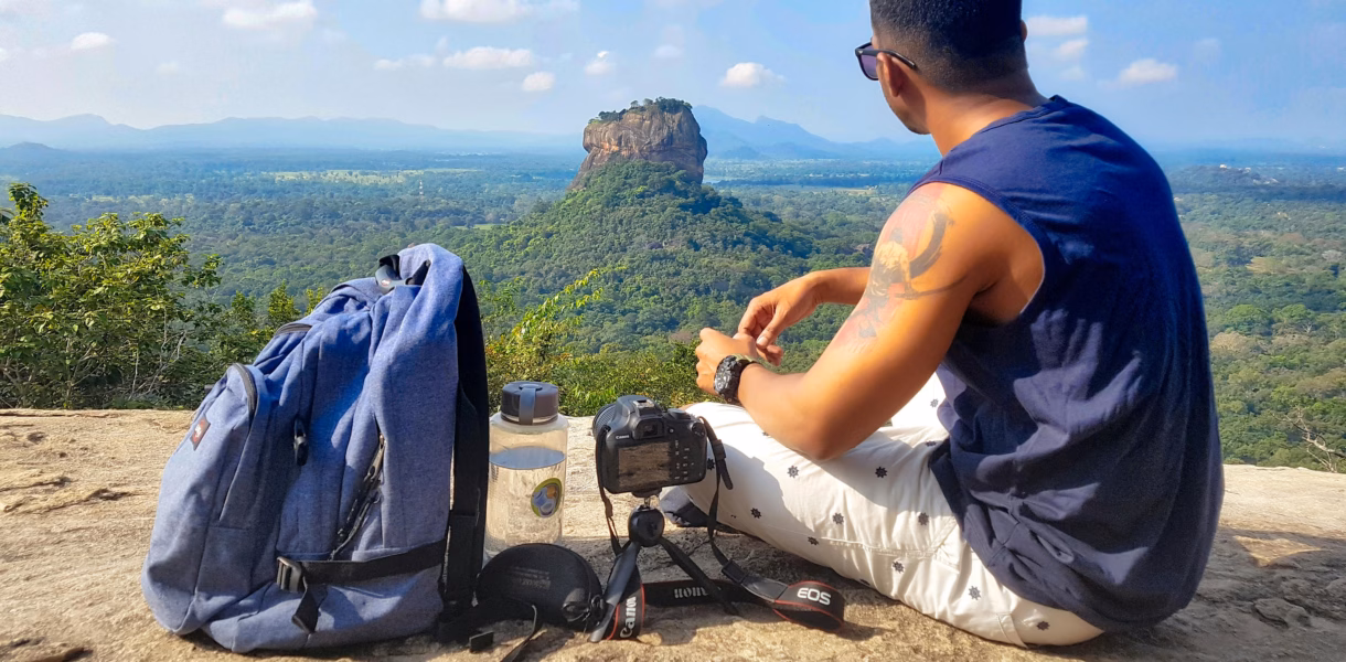 a man with his backpack looking on a landscape