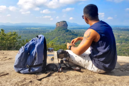 a man with his backpack looking on a landscape
