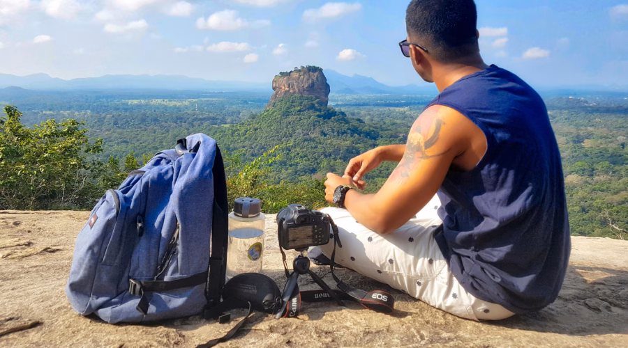 a man with his backpack looking on a landscape