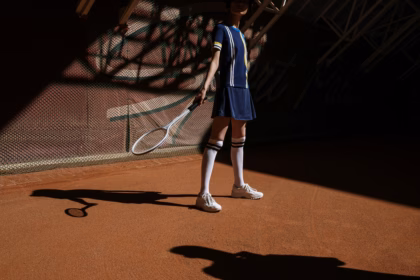 a girl is playing tennis on the field