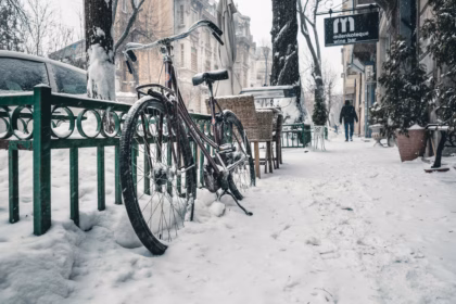 bike on a snow covered street in winter city in europe