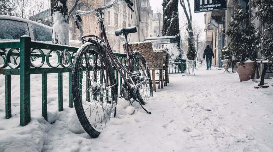 bike on a snow covered street in winter city in europe