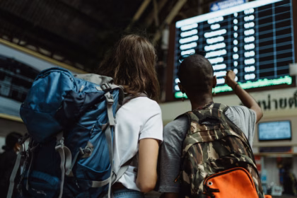 people backpacking on a trip in a train station