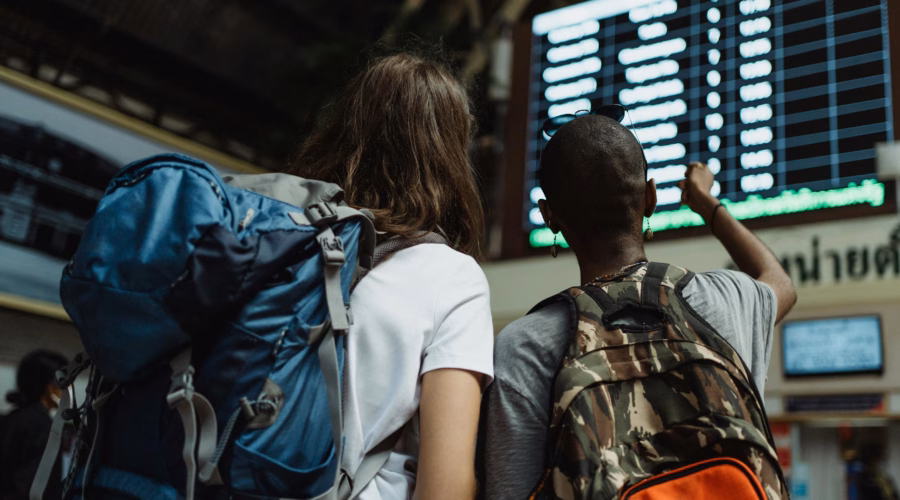 people backpacking on a trip in a train station