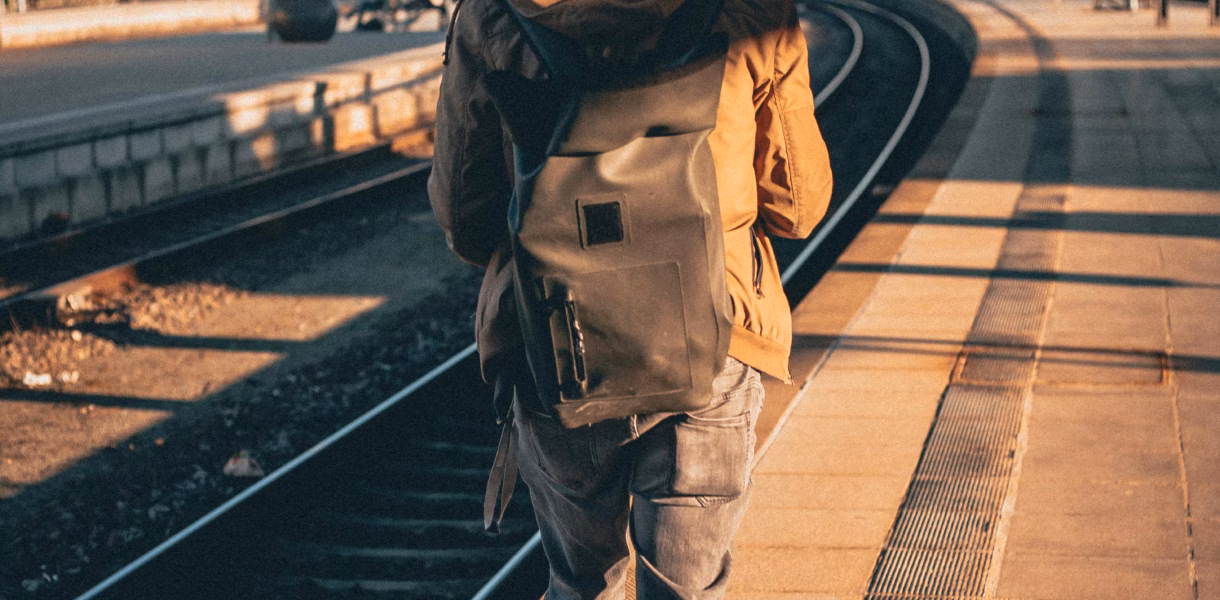 a man walking on train tracks for interrail