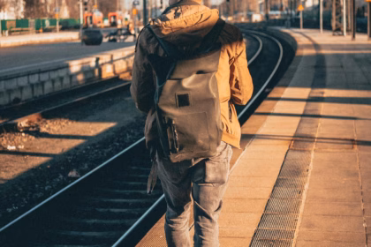 a man walking on train tracks for interrail
