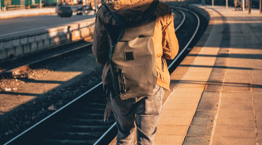 a man walking on train tracks for interrail