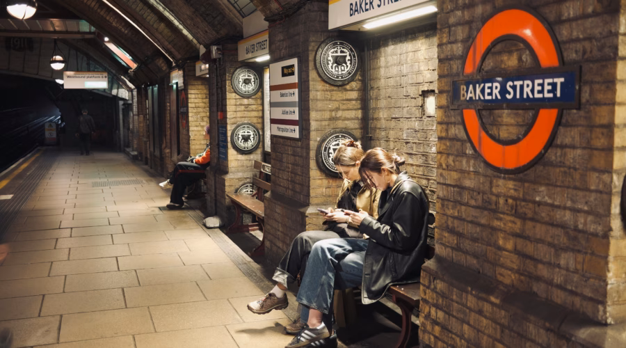 people sitting on a bench in London Underground