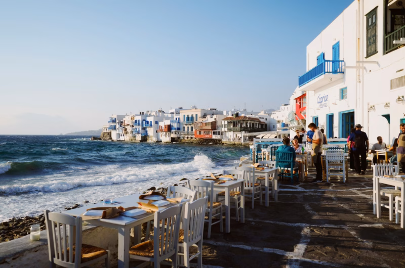 Tipping in Greece - Restaurant service with view of Aegean Sea in Mykonos