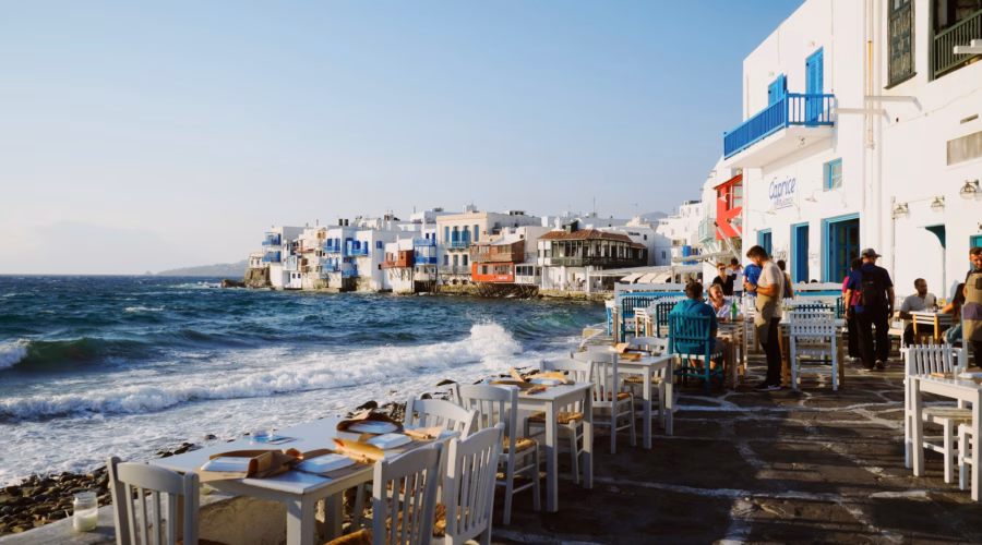 Tipping in Greece - Restaurant service with view of Aegean Sea in Mykonos
