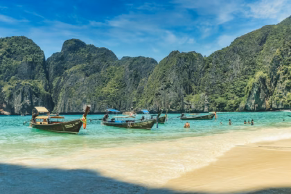 Best time to visit Thailand tropical beach with longtail boats during perfect weather season