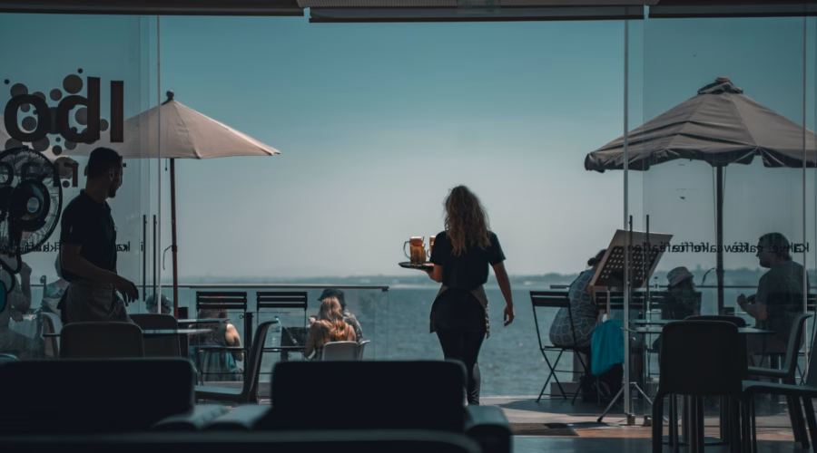 waitress serving customers in a portuguese restaurant: tipping in Portugal