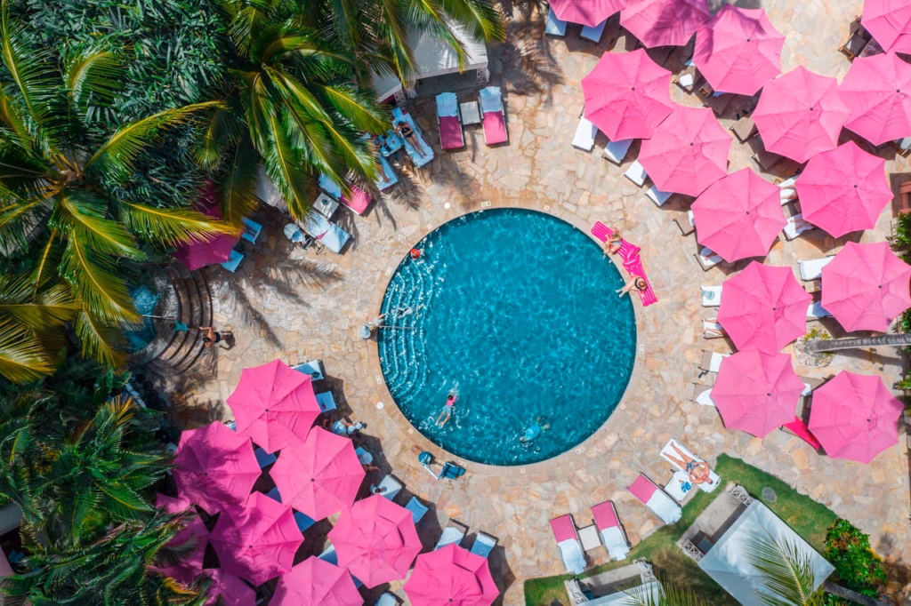 hawaii resort with swimming pool and pink umbrellas