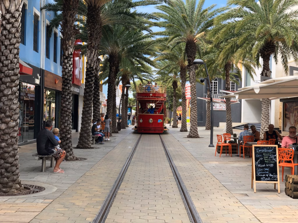 oranjestat street with tram: is aruba expensive to live