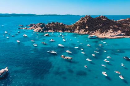 island view with boats: is sardinia expensive?