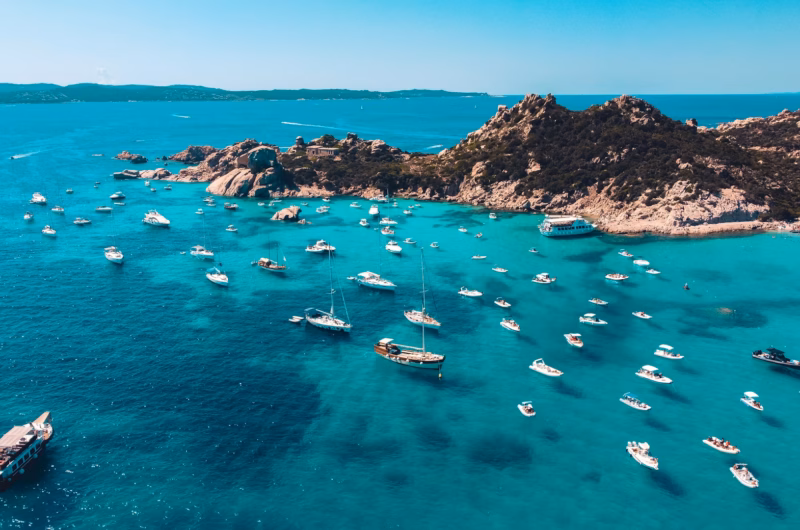 island view with boats: is sardinia expensive?