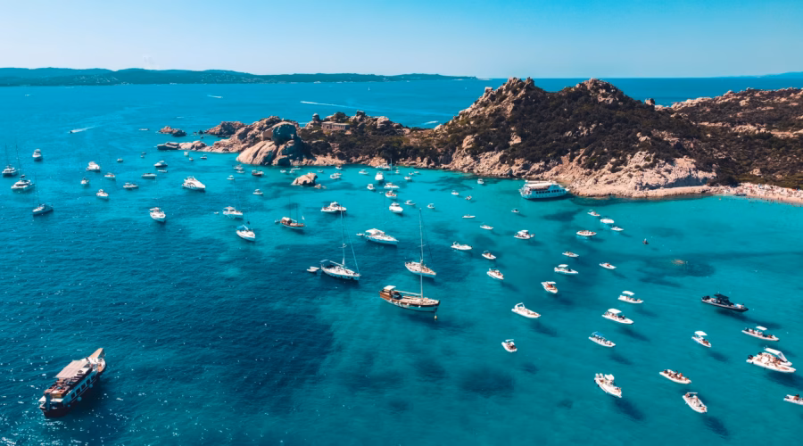 island view with boats: is sardinia expensive?