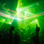 people dancing inside room with green lights