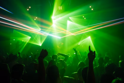 people dancing inside room with green lights