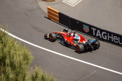 A formula 1 car speeds around a racetrack.