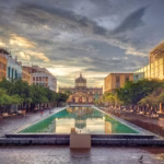 a city square with a fountain in the middle of it