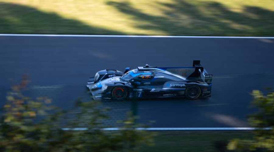 Race car speeding on a dark track.