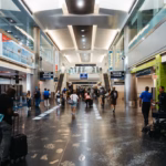 a group of people walking through an airport