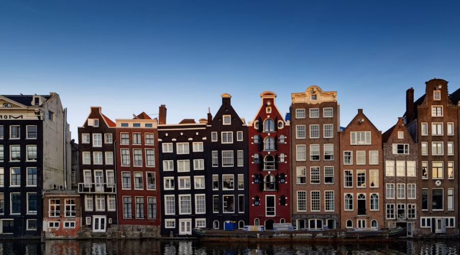 red and white concrete building beside body of water during daytime