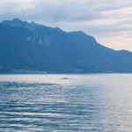 a lone boat in the middle of a large body of water