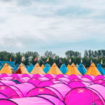 a large group of pink tents sitting next to each other