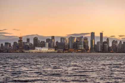 A view of a city from the water at sunset