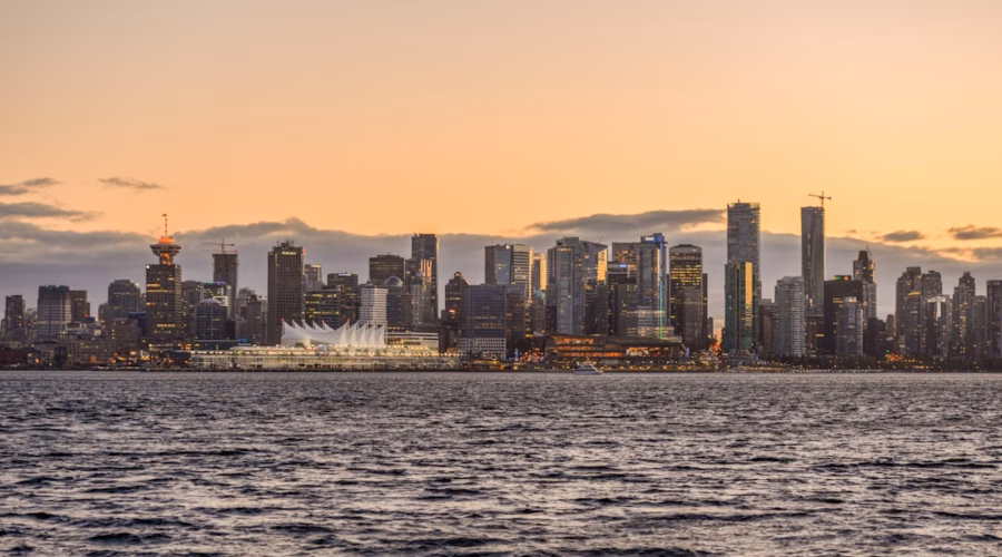 A view of a city from the water at sunset