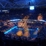 Crowd inside an indoor tennis arena during a match