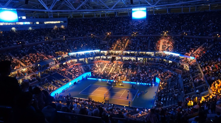 Crowd inside an indoor tennis arena during a match