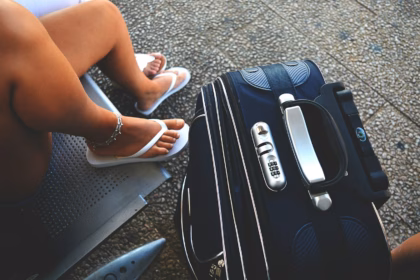 Traveler waiting with luggage, planning a Black Friday travel deal