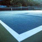 Indoor tennis court under stadium lights