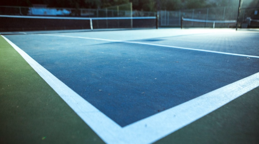 Indoor tennis court under stadium lights