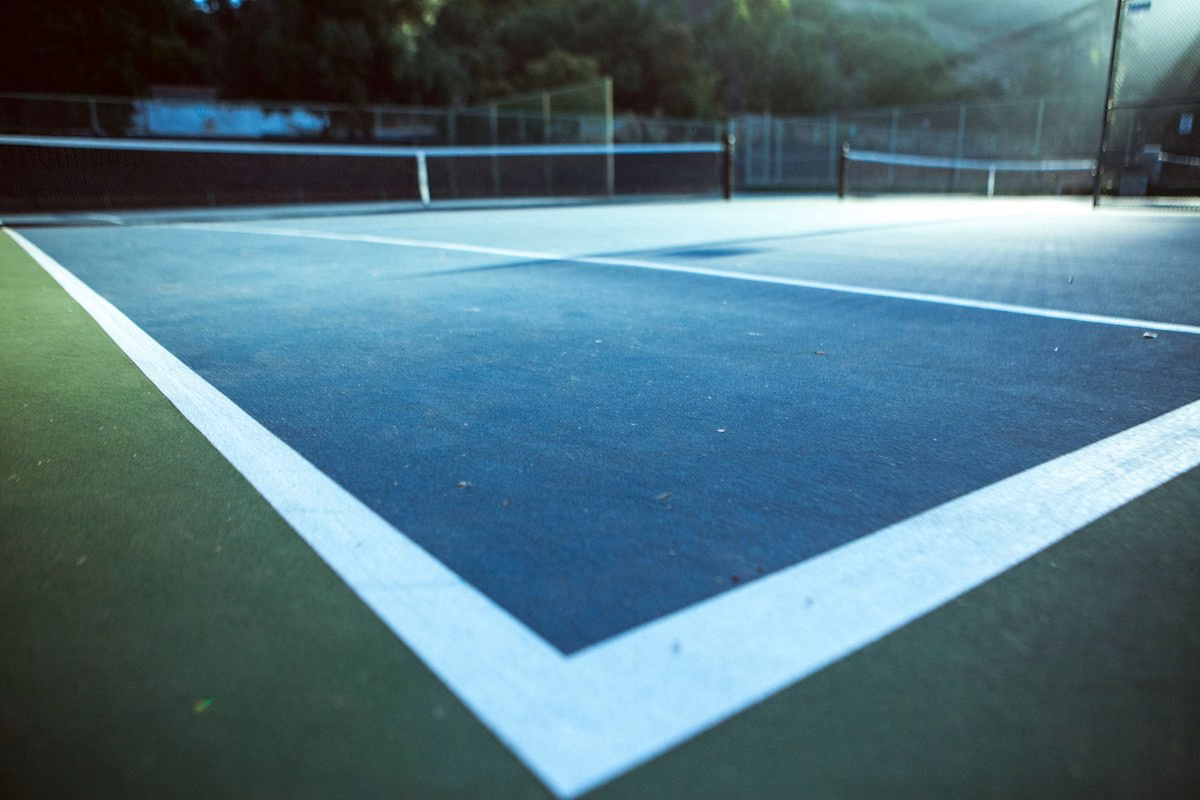 Indoor tennis court under stadium lights