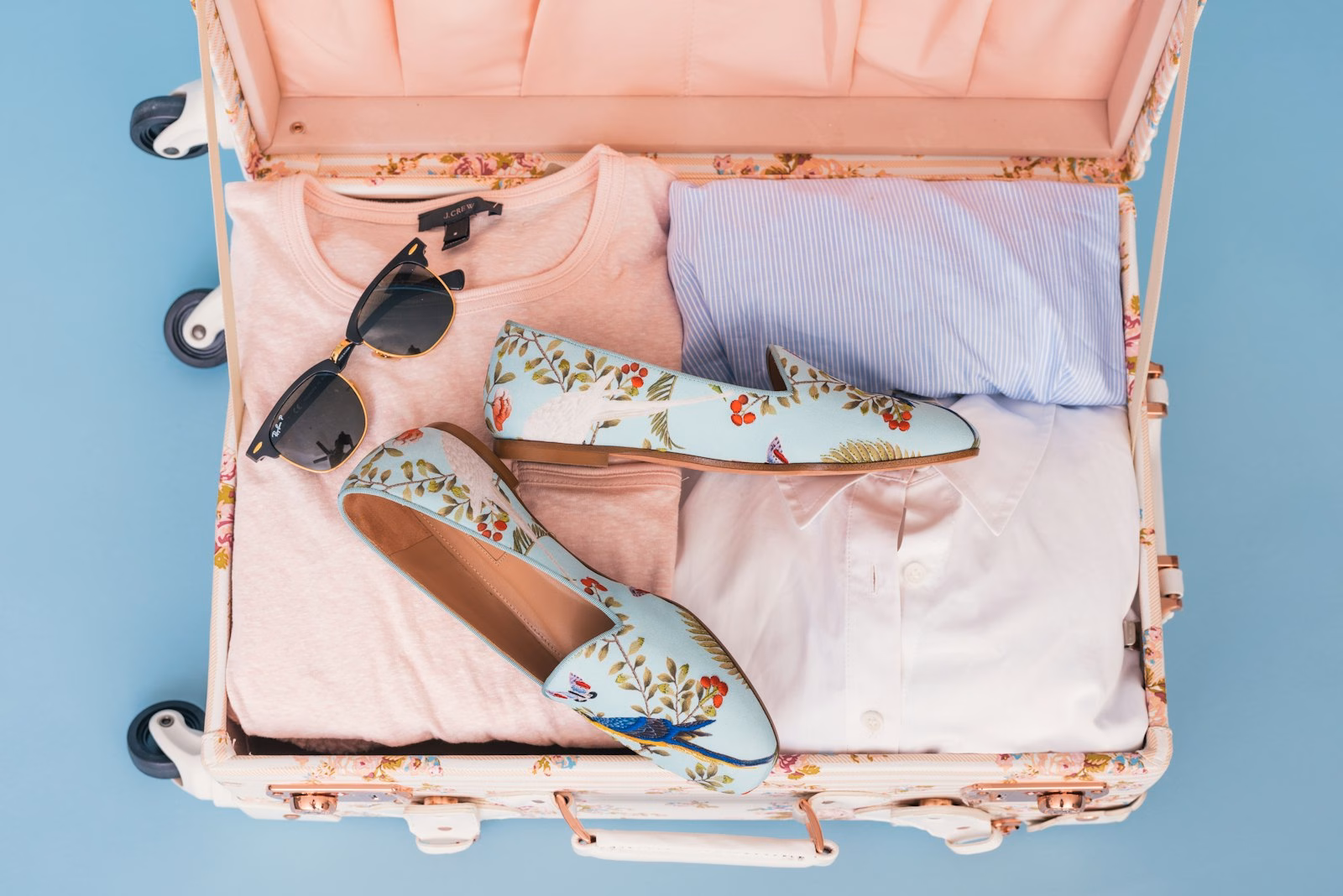 Clothing folded and organized inside an open suitcase
