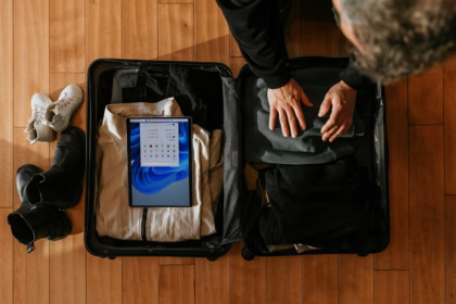 Overhead view of a traveler packing a suitcase for a multi-city trip