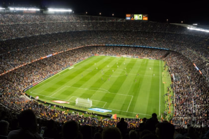 Allianz Stadium Turin guide: fans watching an evening football match under floodlights