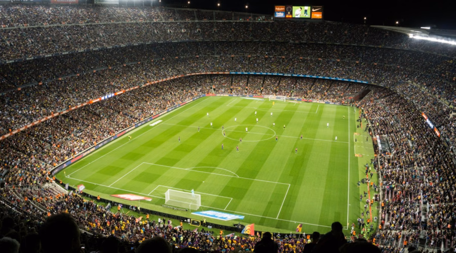 Allianz Stadium Turin guide: fans watching an evening football match under floodlights