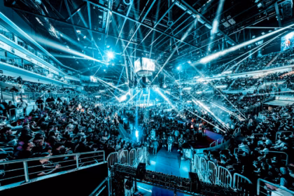 Lanxess Arena Cologne guide: concert crowd under blue stage lights in an indoor arena