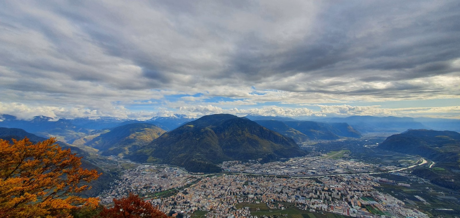 Aerial view of Bolzano, home of the Bolzano Christmas market, with the mountains behind