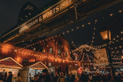 Crowds walking through a Christmas market in Toronto's Distillery District
