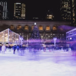 Skaters on an outdoor ice rink at night in New York City