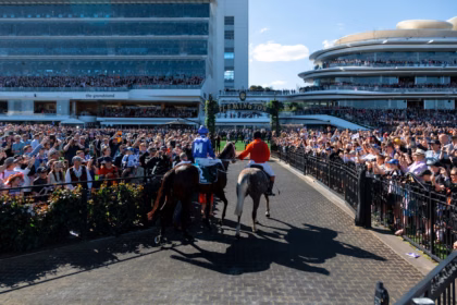 Melbourne Cup 2026 crowd watching horse racing at the track